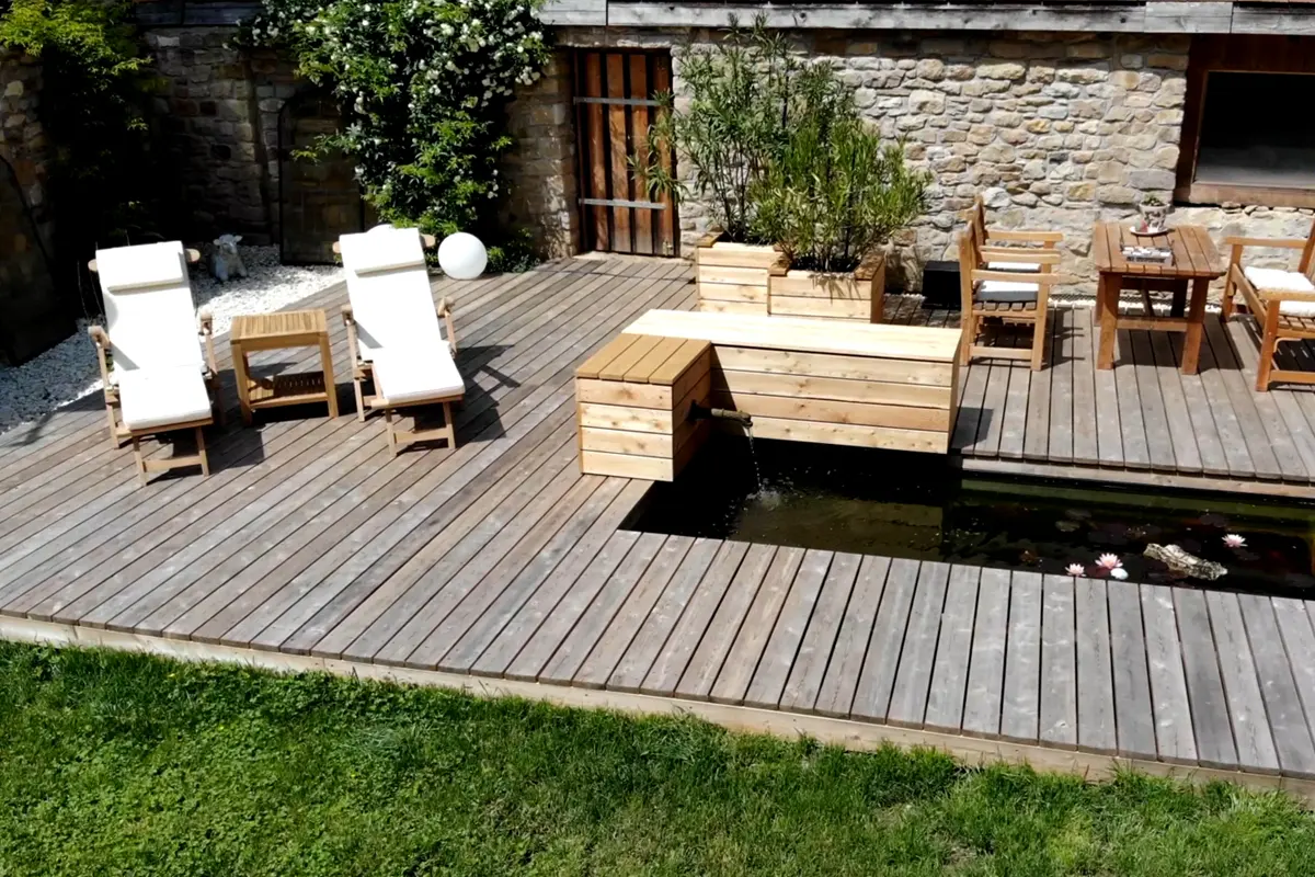 Holzdeck mit Liegen, Tisch und Teich im mediacraft Demogarten
